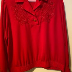 Red blouse, size 18 polyester with gold buttons on cuffs of long sleeve.